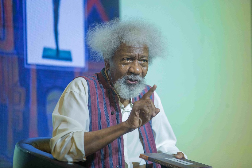 Wole Soyinka speaks at an event, addressing concerns about excessive security escorts.