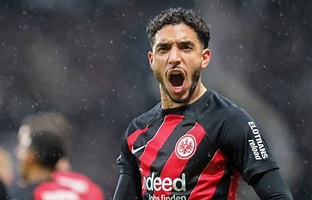 soccer player with his mouth open captures a moment of joy or astonishment during the game.