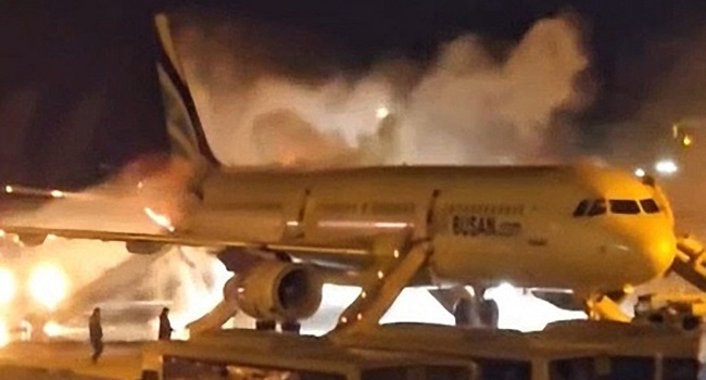 Fire authorities work to extinguish a fire that broke out on an Air Busan passenger plane at Gimhae International Airport in Busan on January 28, 2025. (Photo by YONHAP / AFP)