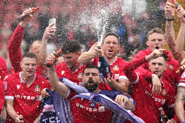 Wrexham eye Premier League after securing Championship promotion, fueled by smart investment, strong management, and Hollywood-backed ambition.