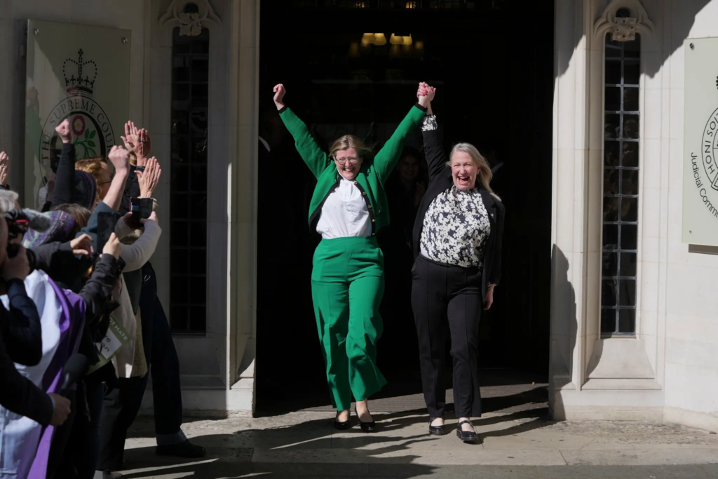 Marion Calder and Susan Smith from “For Women Scotland” celebrating outside of the Supreme Court in London on Wednesday.Credit...Kin Cheung/Associated Press