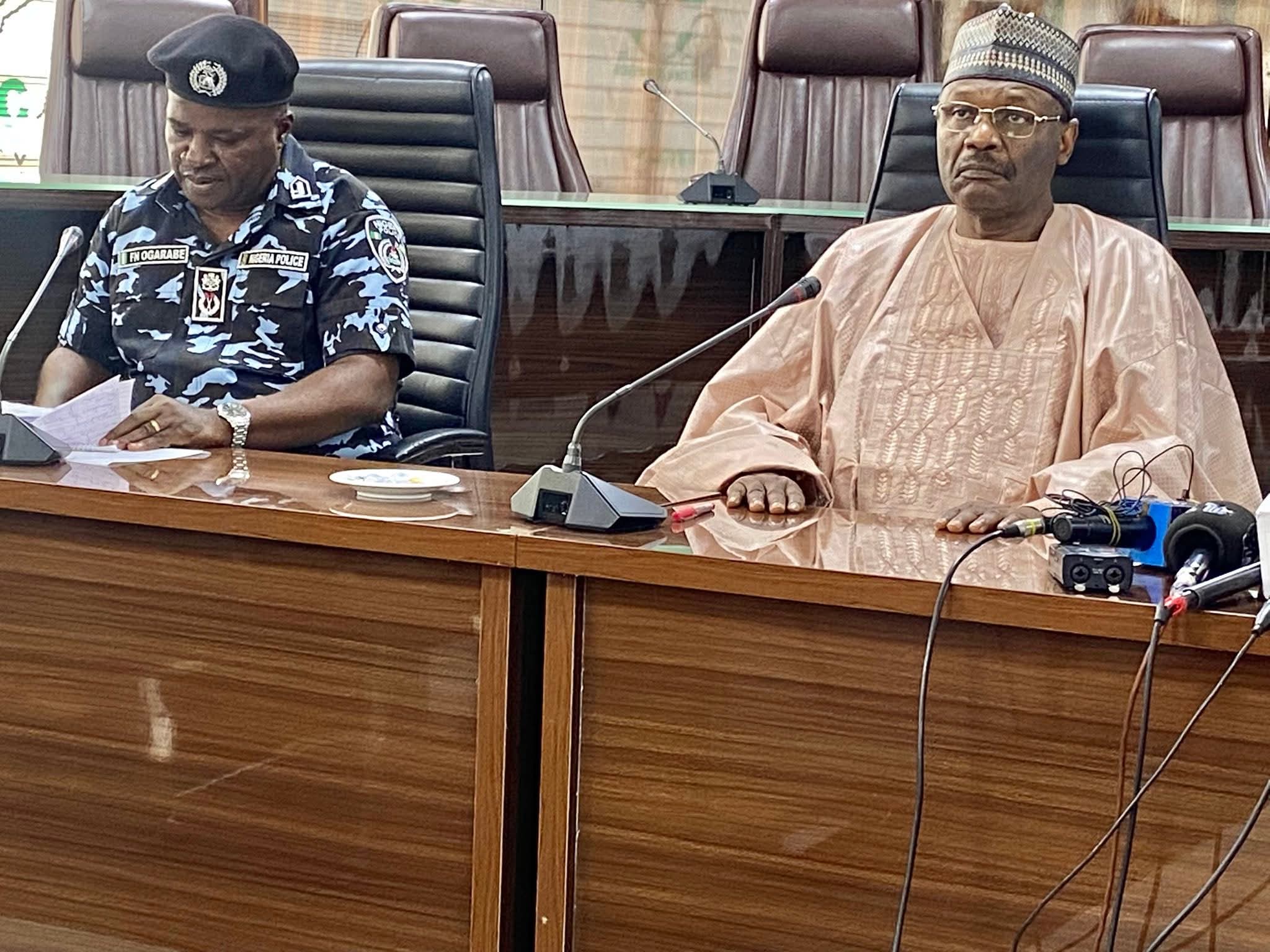 INEC Chairman Mahmood Yakubu and security operatives