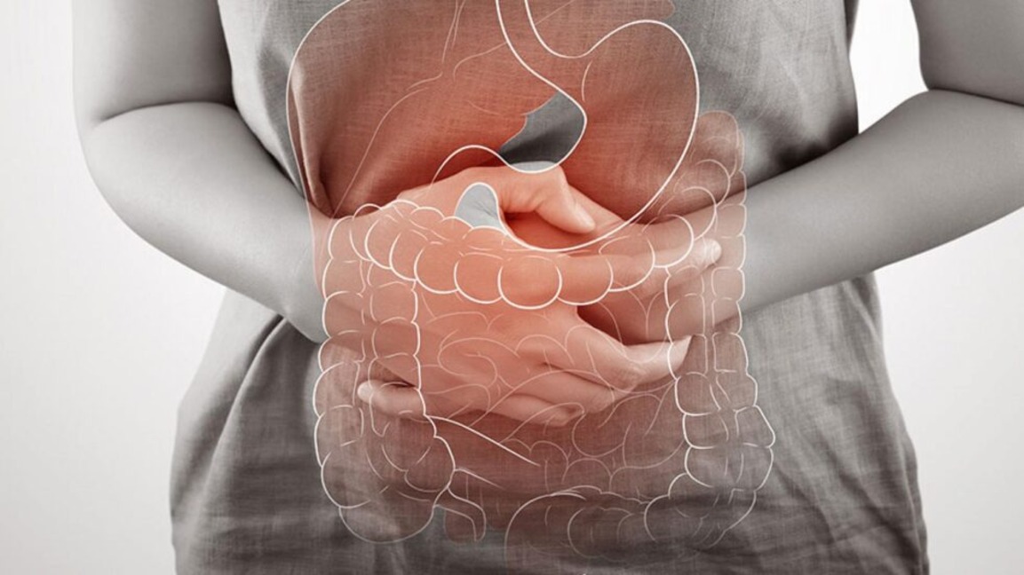A woman holding her stomach due to IBD