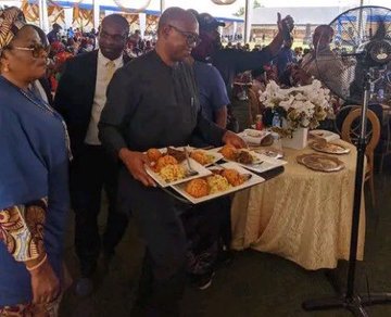 Peter Obi serving food at an event
