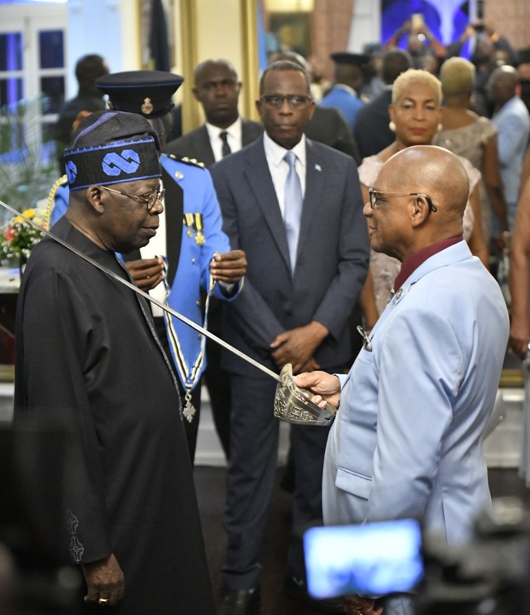 President Bola Ahmed Tinubu receives the insignia of Knight Commander of the Order of Saint Lucia (KCOSL) during an official ceremony in Castries, standing beside Saint Lucian officials, as part of his state visit to the Caribbean island.