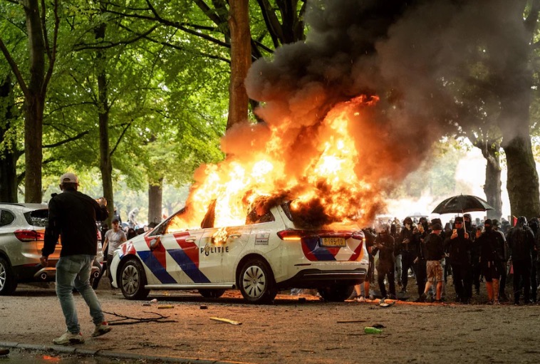 A police car set ablaze during protest