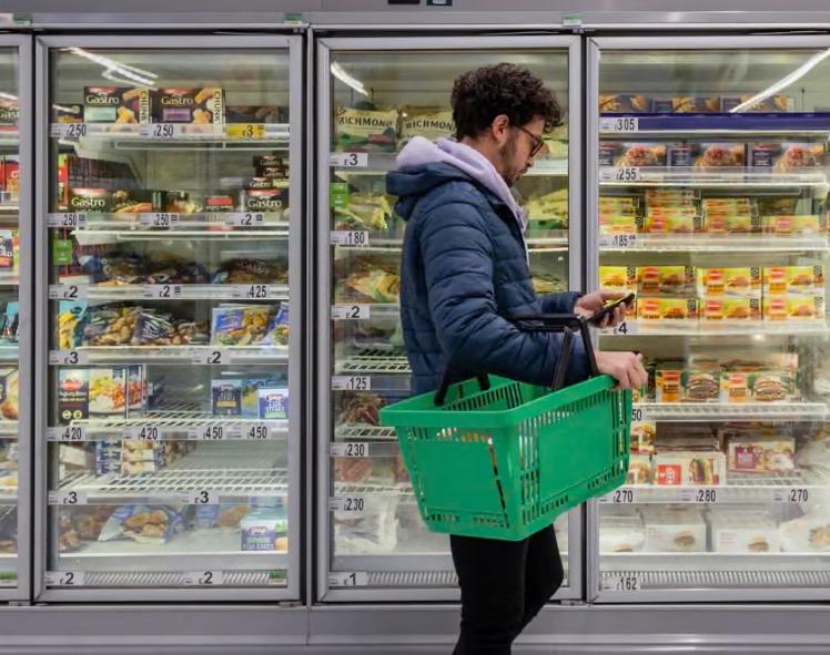 A consumer trying to buy foodstuffs at the supermarket