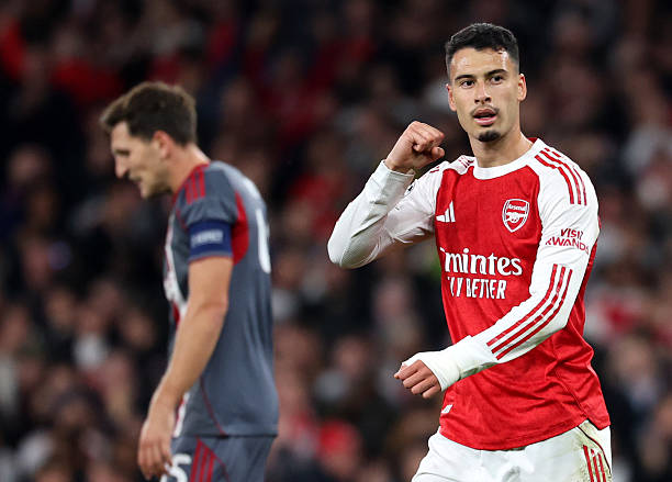 Martinelli’s rebound and Saka’s stoppage-time strike sealed a 2-0 win for Arsenal over Olympiakos, keeping their perfect Champions League start alive.