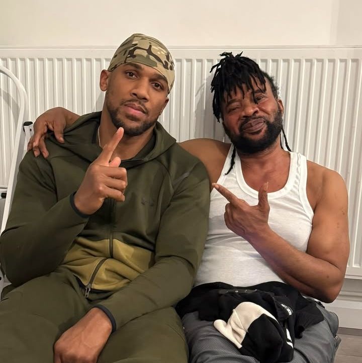 Anthony Joshua with the families of his late friends 